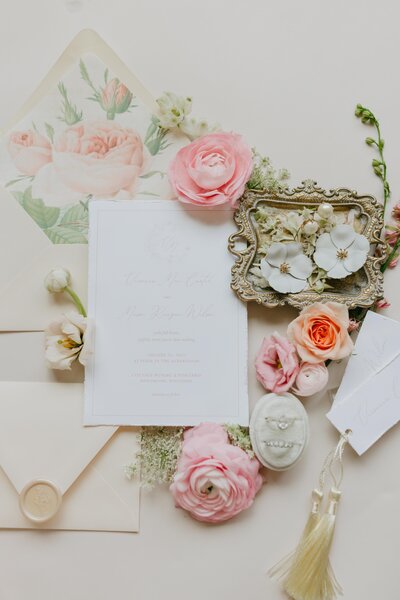 wedding invitation suite flatlay with pink flowers