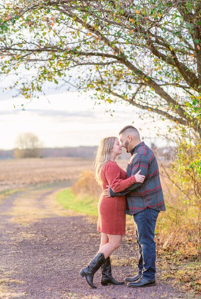 Couple take Engagement Photos during Golden Hour in a field in Fredericksburg, Virginia.