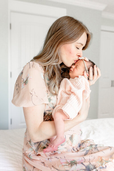 Lifestyle Newborn Session, Baby girl on bed with momma, taken by Ann Arbor Newborn Photographer