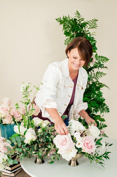 Pam, owner of Petal Barn, working on designing a wedding bouquet