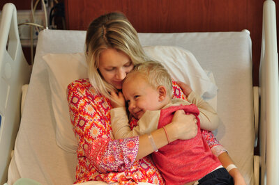 mother holding toddler in hospital