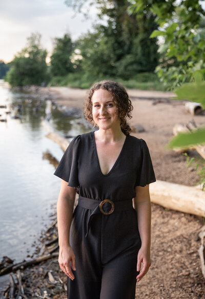 A solopreneur walks towards camera during her personal branding photoshoot on the beach.