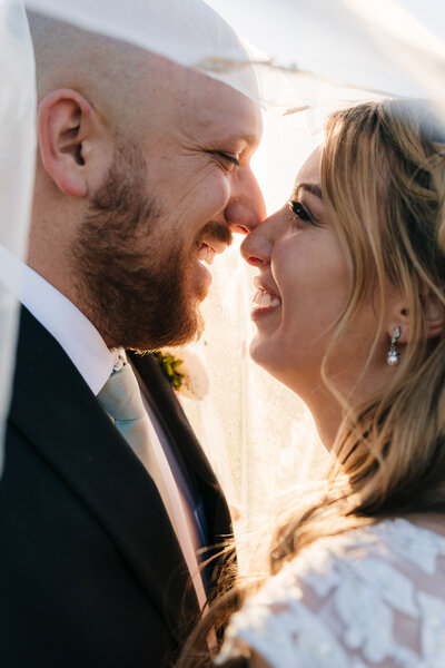 Lovely couple facing each other sharing an intimate moment during their wedding at Revere Golf Club.