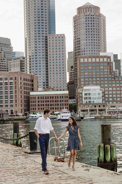 Couple Posing Next To Boston Skyline