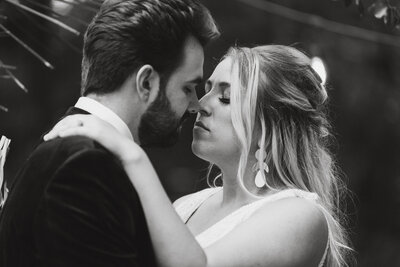 Couple slowly kiss after saying vows during their upstate New York forest wedding.