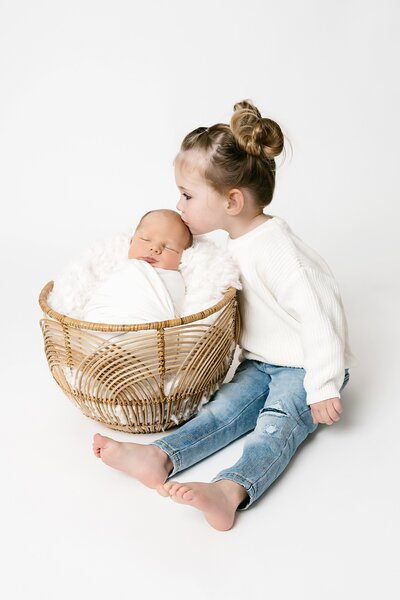 lifestyle newborn session with mom, dad, baby and dog in nursery