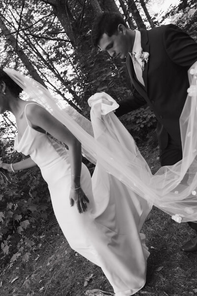 Groom carrying brides dress at new haven connecticut wedding 