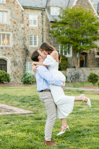 engaged couple posing by a stone church