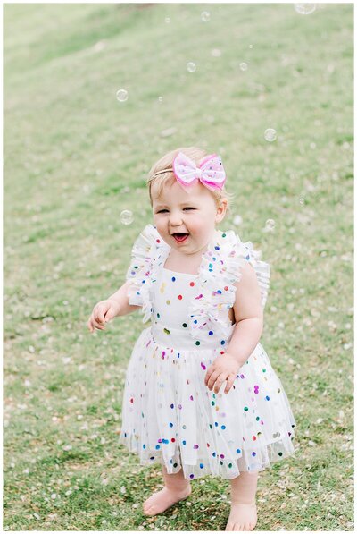 Sweet girl just turned 1 and is playing with bubbles.  Pittsburgh PA Family Photographer