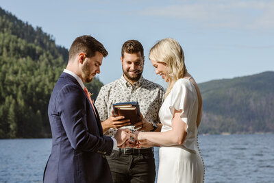 Couple exchanging rings on the shores of Lake Crescent