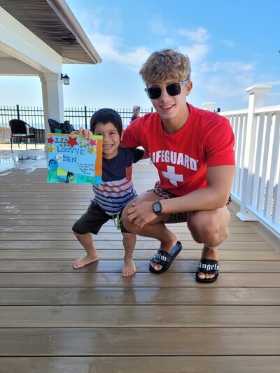 The lifeguard and student swimmer share a joyful moment