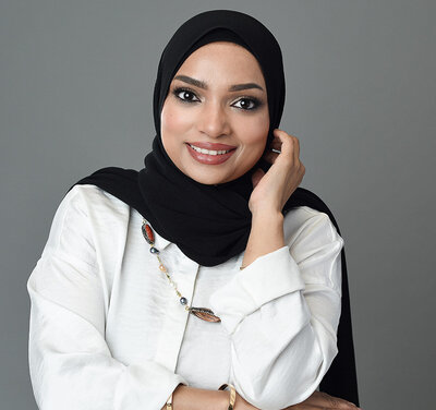 Professional headshot in studio of Muslim woman with headscarf