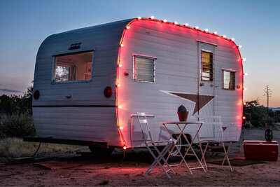 Destination Branding Gatos Trail mini airstream trailer set in desert rimmed with red glowing lights