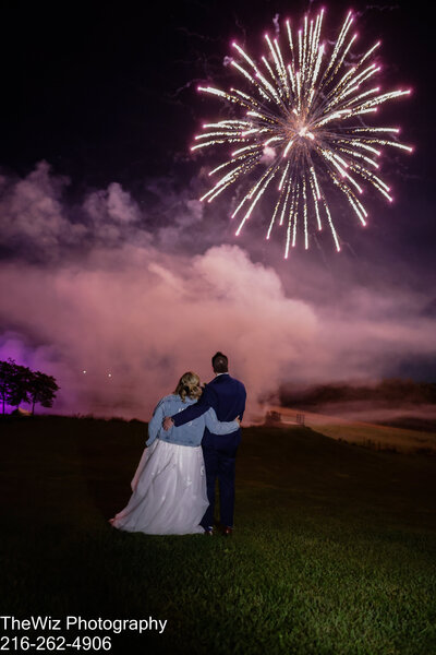 Captivating Pennsylvania wedding photography. This photo captures the romance and celebration of the couple enjoying fireworks at Lingrow Farms