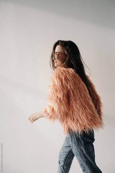 fashionable girl wearing a pink fur coat