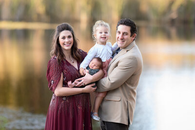 Family of four standing by the lake photo taken by Southeast Michigan Family Photographer Kat Figlak
