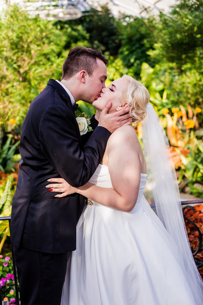 Bride and groom share first kiss at Phipps Conservatory wedding in Pittsburgh, PA