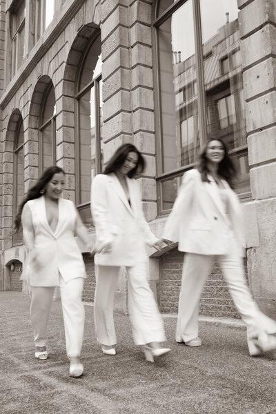 three professional women smiling and walking down the street