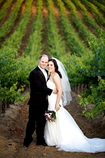 Bride and Groom in vineyard at Leoness Winery
