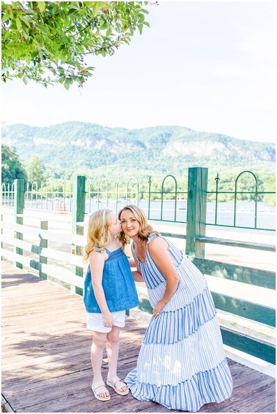 daughter kissing mom with lake lure in the background