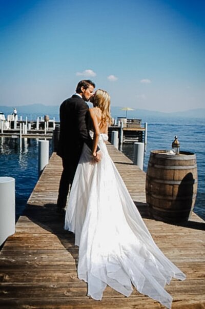 Couple kissing on the dock at Quist estate on the west shore of Lake Tahoe