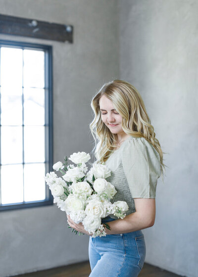 McKayla is a Utah Florist holding a white garden bridal bouquet.
