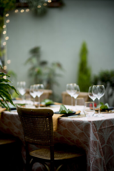 Picture of table with wine glasses and leaves as decor