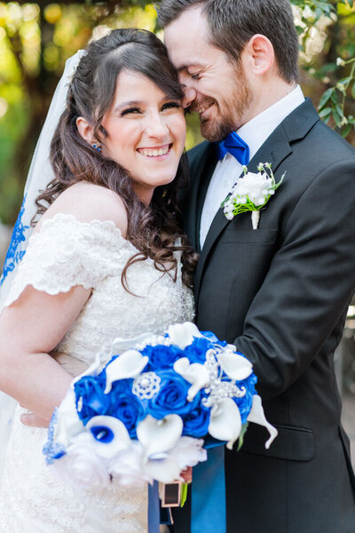 couple holding each other at butterfly themed wedding  at the Tucson Botanical Gardens