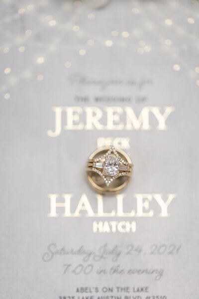 Ring Detail shot on top of the wedding invitation  taken  at Lola Beauty, Austin, TX