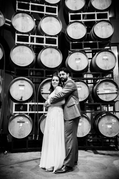 Wedding couple in front of barrels Lynchburg Tn Wedding Photographers