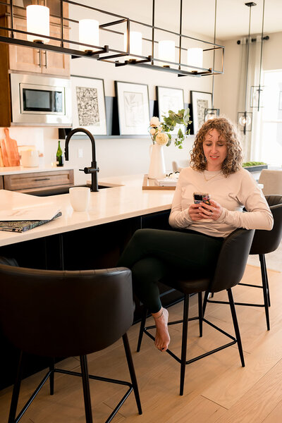 Lauren Haug reviewing real estate documents while preparing a home listing in Loveland, CO