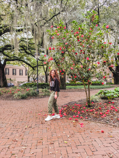 Kimberli in Savannah Square with flowers blooming.