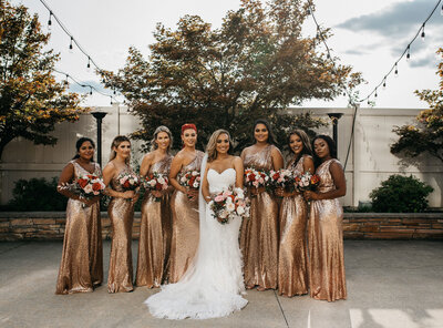 bride and bridesmaids holding flower bouquets