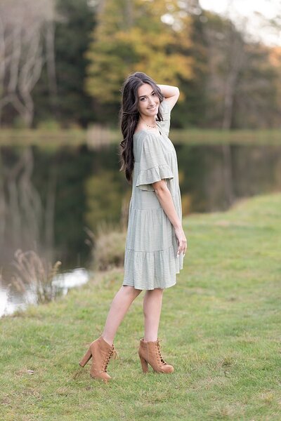 Close-up of high school senior girl standing by a lake