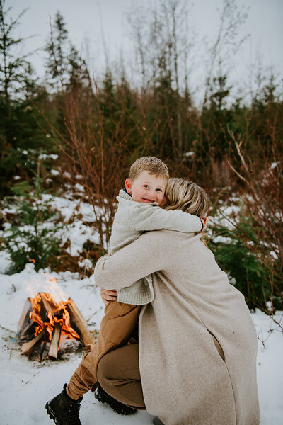 Mom and son hugging during a beautiful snowy family session on the Sunshine Coast B.C.