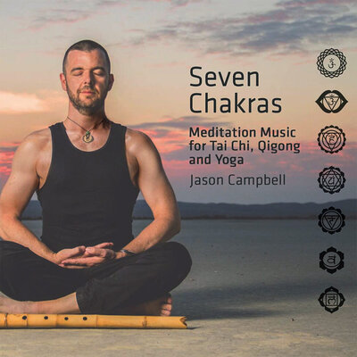 Album Cover Seven Chakras Jason Campbell sitting in lotus position in desert at sunrise wood flute on sand in front of him