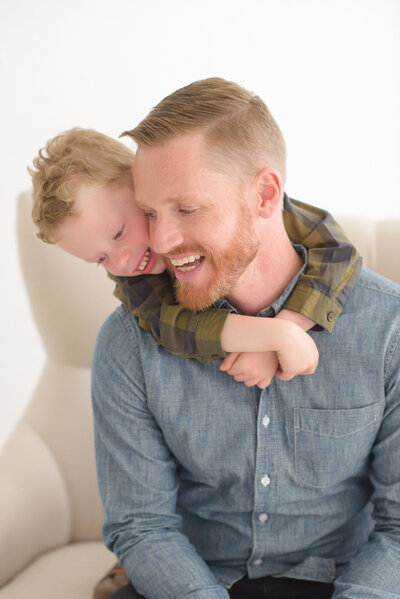 Father and son cuddling in Boise photographers studio.