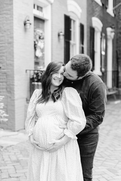 A black and white dc newborn photographer photo of an expecting couple in Old Town Alexandria