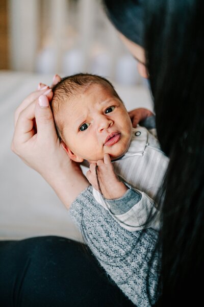 Baby girl looking at the camera during lifestyle newborn session in Orlando