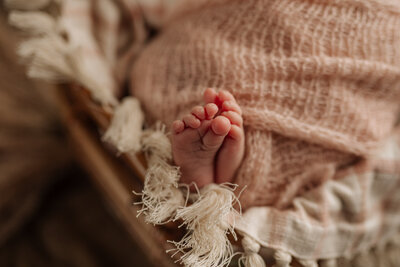 baby in white sleeper at Pittsburgh newborn  photoshoot