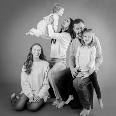 Fun family playing around in a candid studio family session