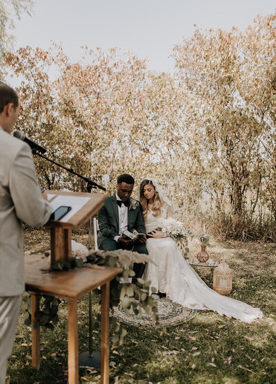 Bride and groom reading scripture during their wedding ceremony