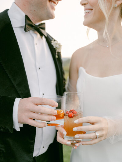 Couple holding their cocktails after getting married at Pipping Hill Farm and Vineyard in Charlottesville Virginia photographed by Charlottesville Wedding Photographer Amanda Adams Photography