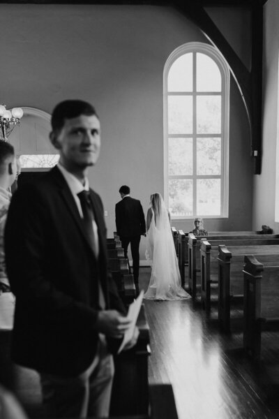 bride and groom walking down aisle together in pensacola florida