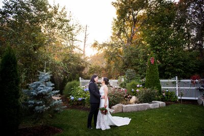 Couple standing together in a garden facing each other