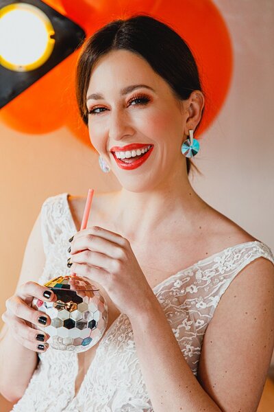 Bride with drink shaped like a disco ball