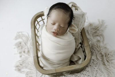 Newborn baby smiling up towards mom and dad