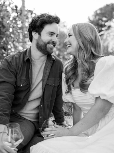 couple smiling at each other during their engagement photography session in atlanta