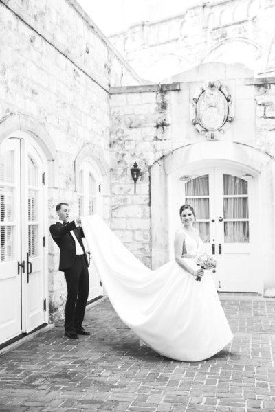austin wedding photographer chateau bellevue bride groom looks under dress