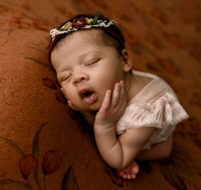Newborn photo of a baby girl with a beautiful headband